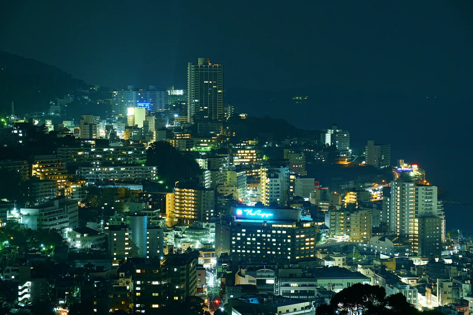 The lights of Atami Onsen climbing the hills above the bay at night