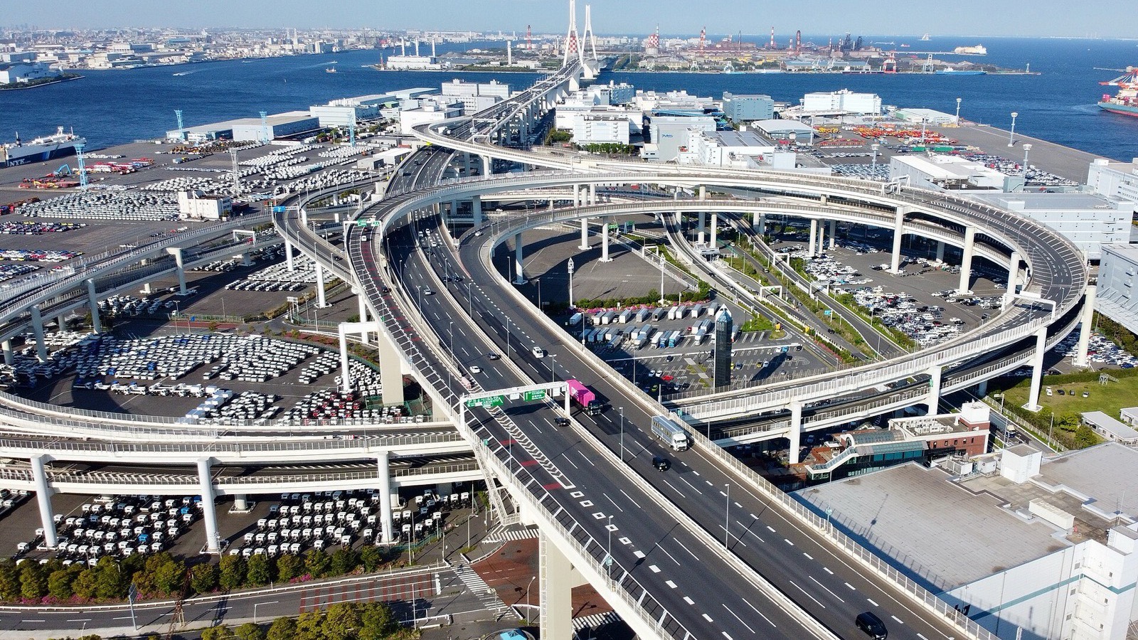 Aerial view of Daikoku Junction and its looping ramps, with Daikoku Parking Area inside the expressway interchange in Yokohama