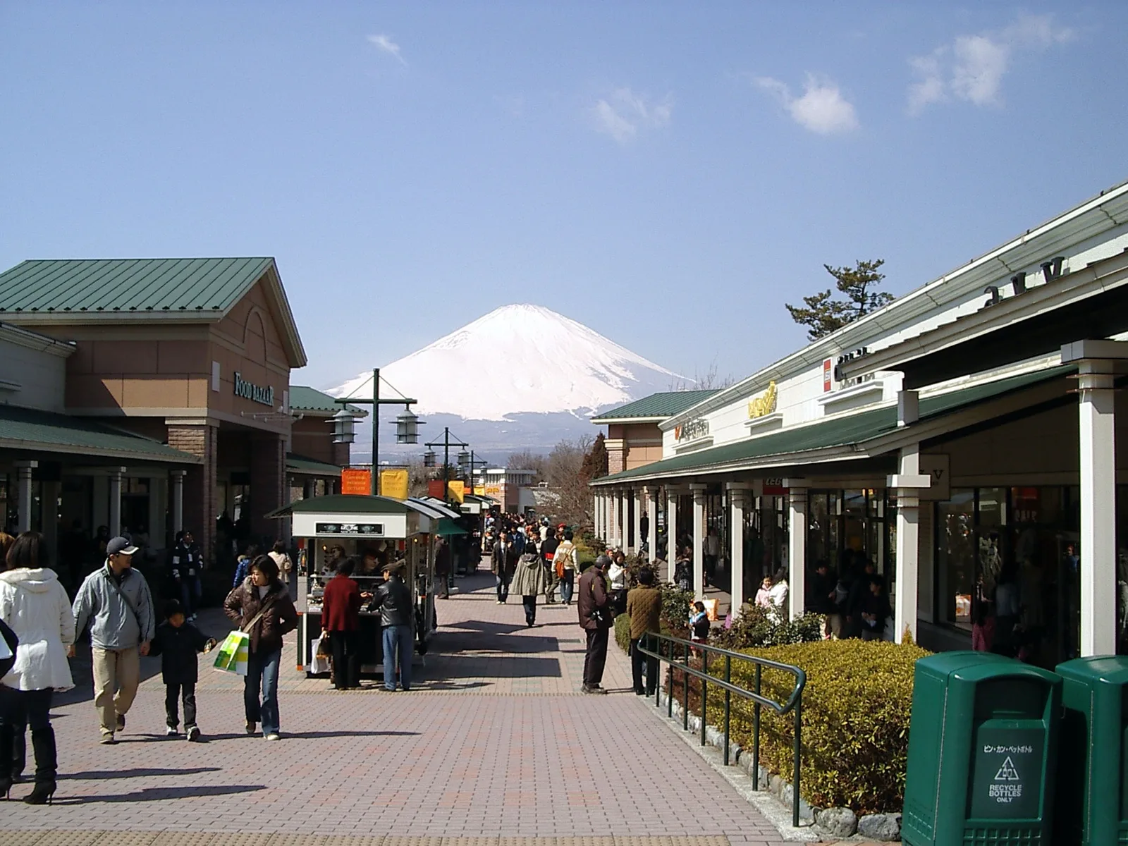 The main walkway of Gotemba Premium Outlets with snow-capped Mt Fuji at the end