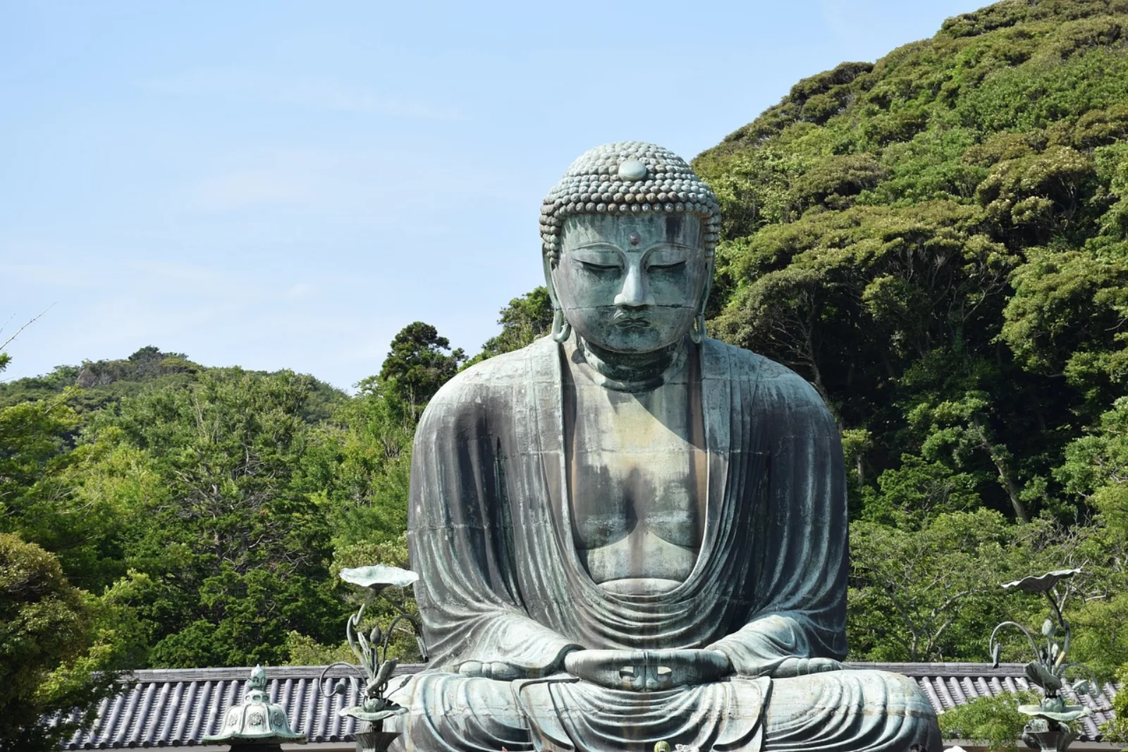 The bronze Great Buddha of Kamakura at Kotoku-in, surrounded by green hills