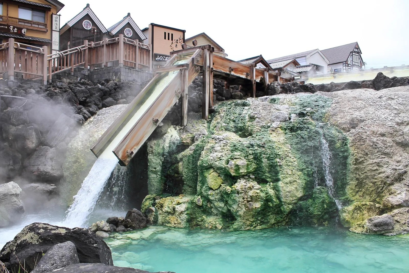 Hot spring water flowing through wooden channels at Yubatake in Kusatsu Onsen