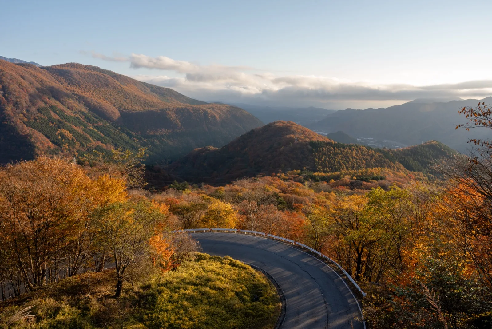 The Irohazaka road winding through red and gold autumn forest above Nikko