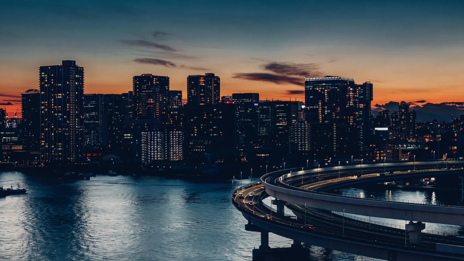 Rainbow Bridge, the elevated loop road and the Tokyo Bay skyline at dusk