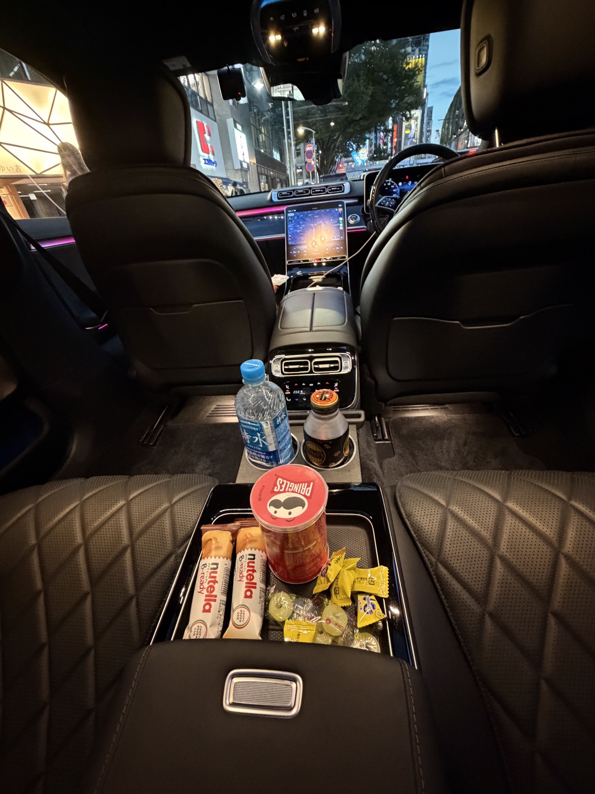 Complimentary refreshments tray with water, coffee and snacks in a Driven Tokyo chauffeur car